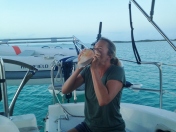 Our friends on R&R taught Mary the art of playing a conch. Tradition to blow at sunset.